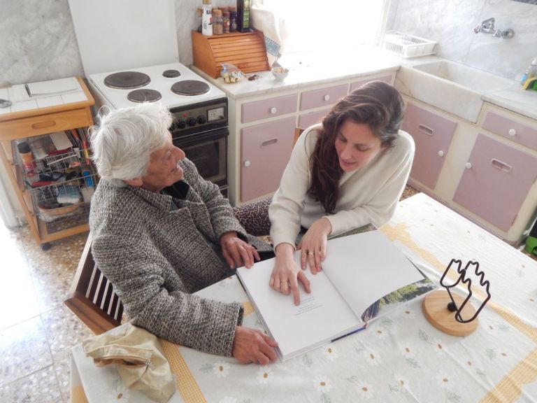 Mina Stone with her Yiayia looking at Cooking for Artists. Photo by Alex Eagleton