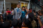 CAPE TOWN, MANENBERG, SOUTH AFRICA - As Lauren-Lee (Lolla) and her prom date walk out of the house everyone cheers at them. The whole neighborhood is standing beneath the rows of clotheslines that run between the two Joyce Court buildings. Everyone wants to see Lolla walk out of the house in her ball gown. CREDIT: Ilvy Njiokiktjien