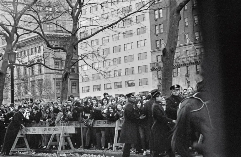 Fans, press, and police await The Beatles’ arrival at the Plaza Hotel, 5th Avenue, photographed from the car, February 1964 © 1964 Paul McCartney under exclusive license to MPL Archive LLP