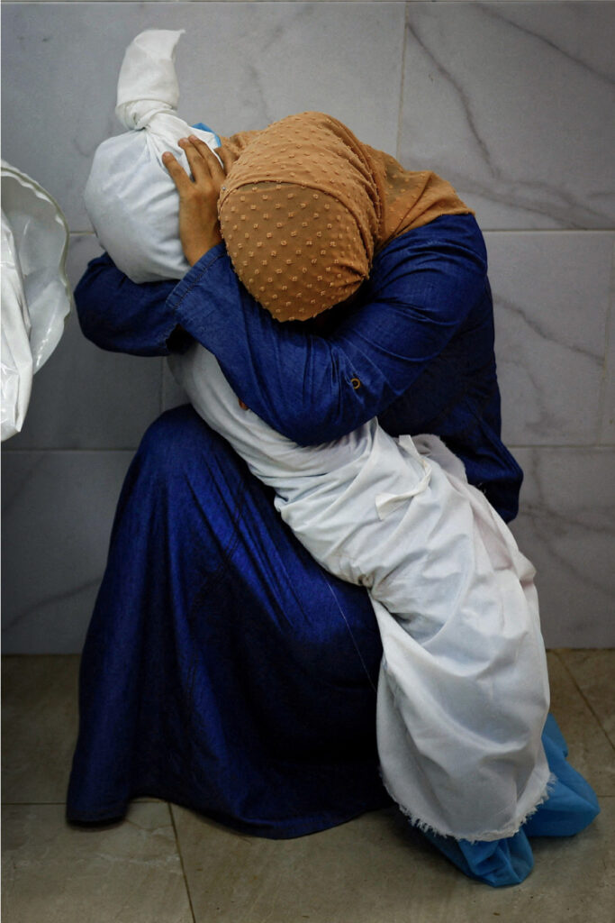 World Press Photo of the Year  A Palestinian Woman Embraces the Body of Her Niece © Mohammed Salem, Reuters